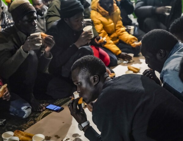 Following evening prayers at Bronx's Masjid Ansaru-Deen mosque, African migrants break Ramadan fast and begin a meal called an iftar, Friday March 15, 2024, in New York. (AP Photo/Bebeto Matthews)